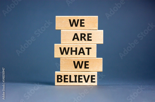 We are what we believe symbol. Concept words We are what we believe on wooden blocks. Beautiful grey table grey background. Business, motivational we are what we believe concept. Copy space.