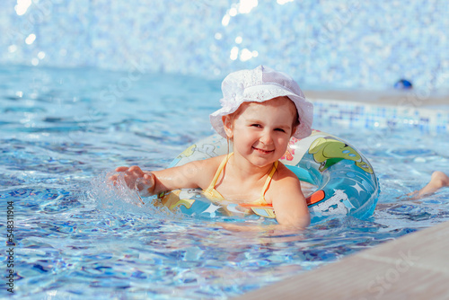 Little girl having fun in swimming pool. © Nadezhda