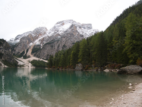 A gloomy autumn morning on the shores of Lake Braies. Dolomites, Italy.