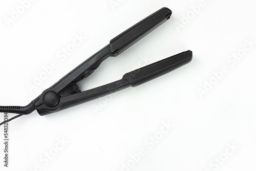 Hair care concept. Metallic rosy ionic professional hair style tool.