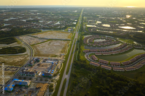 Aerial view of construction site with new tightly packed homes in Florida closed living clubs. Family houses as example of real estate development in american suburbs