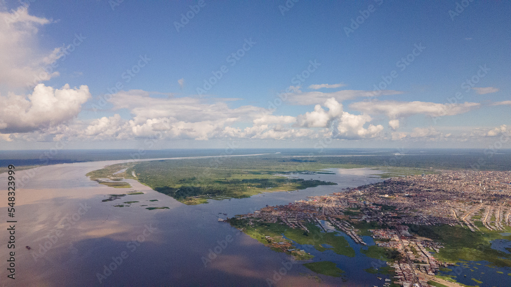Drone aerial image of the Iquitos city on the banks of the amazing Amazon River in Peru, South America.