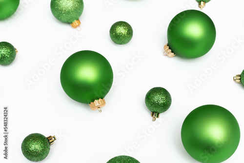 Christmas flatlay composition of green balls on the white background