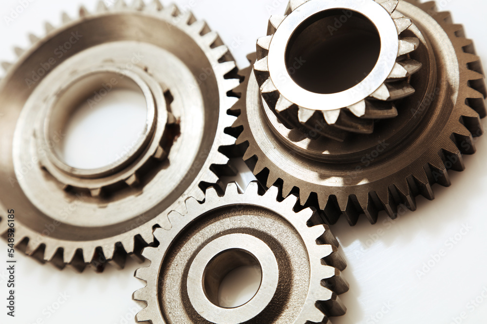Three metal cog gears joining together Three metal cog gears joining together