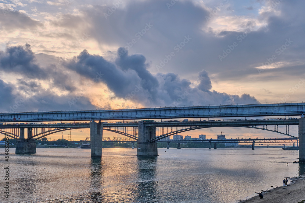 Novosibirsk Metro Bridge over Ob River in Novosibirsk, Russia. Cityscape on sunset