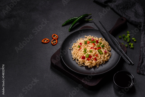 Delicious fresh noodles with sweet pepper, tomato, spices and herbs