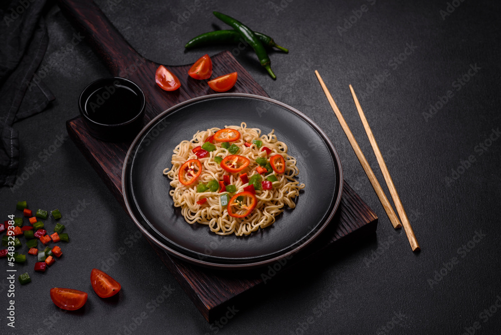 Delicious fresh noodles with sweet pepper, tomato, spices and herbs