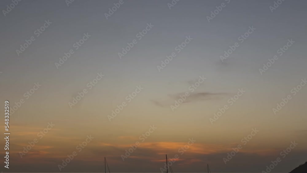 Night falls on the coast of the ocean, timelapse. Yachts floating at sunset. People rest, silhouettes on the shore. Travel and tourism concept Night falls on the coast of the ocean, timelapse. Yachts floating at sunset. People rest, silhouettes on the shore. Travel and tourism concept