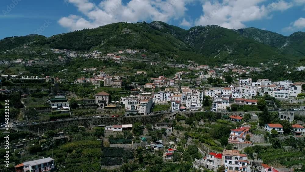 Aerial view of Ravello, Italy. Drone flying smoothly over the road, red roofs of the old town, cliff and mountains Aerial view of Ravello, Italy. Drone flying smoothly over the road, red roofs of the old town, cliff and mountains