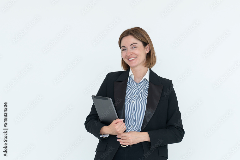 Young attractive and smiling business woman in black suit holding gadget isolated on white. Copy space and place for text concept Young attractive and smiling business woman in black suit holding gadget isolated on white. Copy space and place for text concept