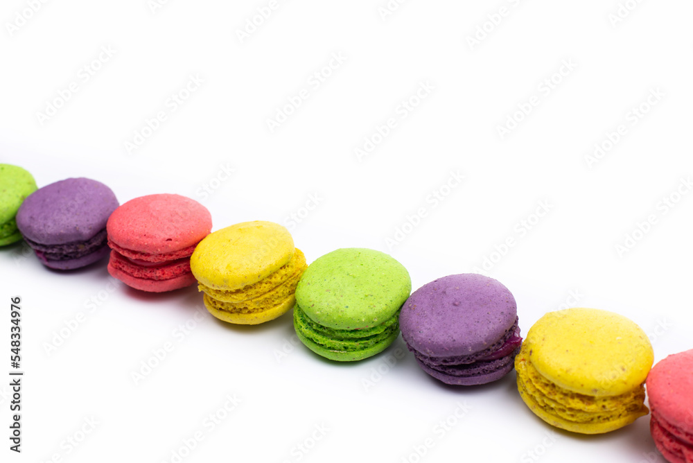 Multicolored macaroons. On a white table background. Cookie dessert Multicolored macaroons. On a white table background. Cookie dessert