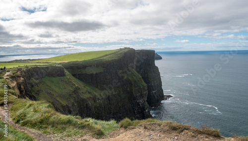 Spectacular view of famous Cliffs of Moher and wild Atlantic Ocean, cloudy day, County Clare, Ireland.