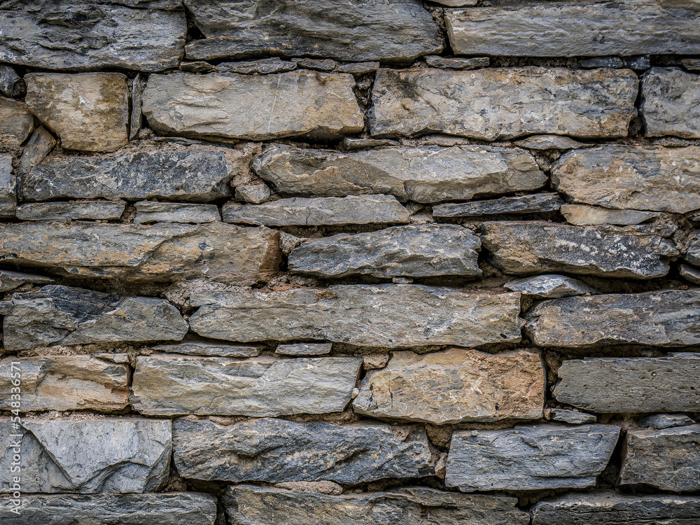 A stonewall made with gray granite slabs cut to various sizes. A stonewall made with gray granite slabs cut to various sizes.