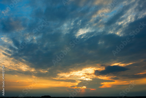 Bright dramatic sky with clouds at sunset