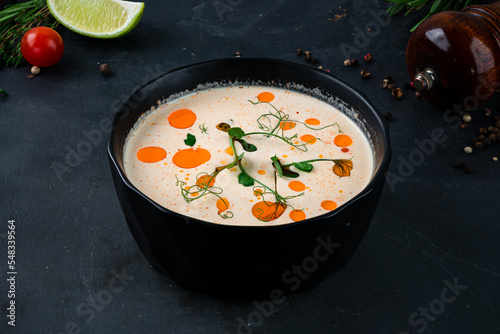 Champignon cream soup served with green peas and oil.