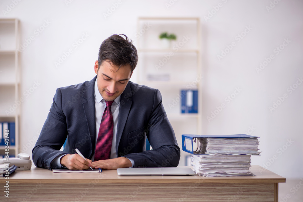Young male employee working in the office