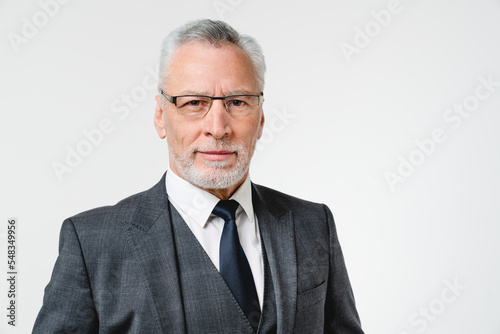 Closeup caucasian mature middle-aged elderly rich successful businessman ceo boss in formal suit with grey hair looking at camera isolated in white background