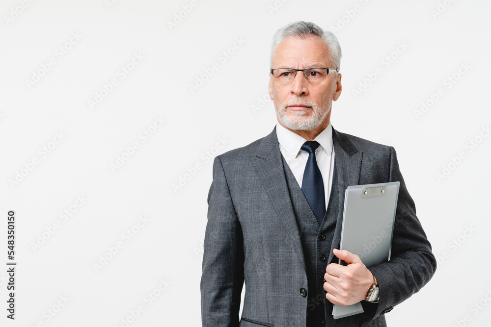 Serious caucasian mature senior businessman ceo boss inspector auditor lawyer inspecting checking the quality of goods with clipboard isolated in white background Serious caucasian mature senior businessman ceo boss inspector auditor lawyer inspecting checking the quality of goods with clipboard isolated in white background
