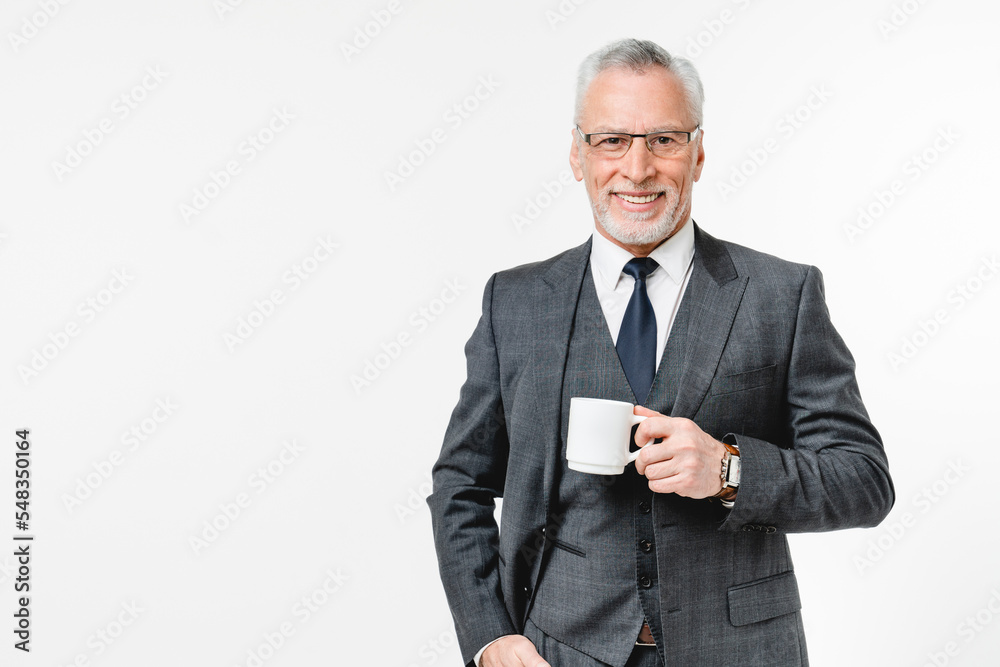 Happy caucasian mature middle-aged senior businessman in formal clothes rich businessman lawyer drinking coffee tea hot beverage having breakfast isolated in white background Happy caucasian mature middle-aged senior businessman in formal clothes rich businessman lawyer drinking coffee tea hot beverage having breakfast isolated in white background