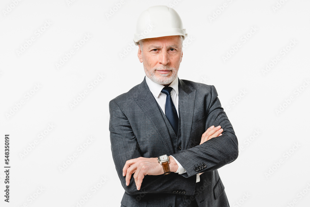 Confident caucasian serious mature senior engineer construction worker architect in hardhat with arms crossed isolated in white background Confident caucasian serious mature senior engineer construction worker architect in hardhat with arms crossed isolated in white background
