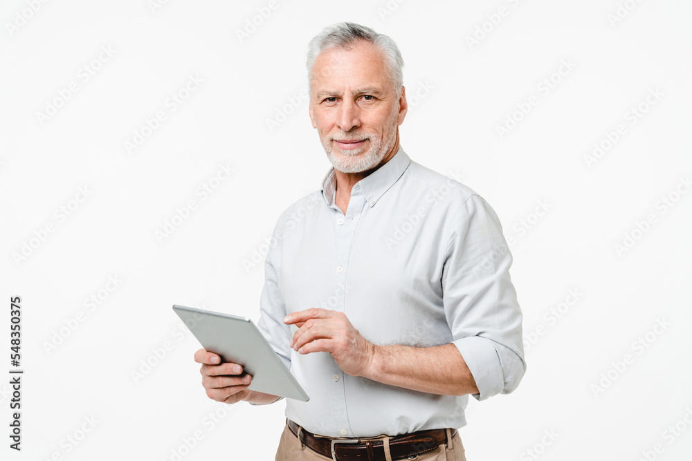 Smart caucasian mature middle-aged senior freelancer grandfather ceo boss teacher professor using digital tablet for remote work online, watching webinars isolated in white background Smart caucasian mature middle-aged senior freelancer grandfather ceo boss teacher professor using digital tablet for remote work online, watching webinars isolated in white background