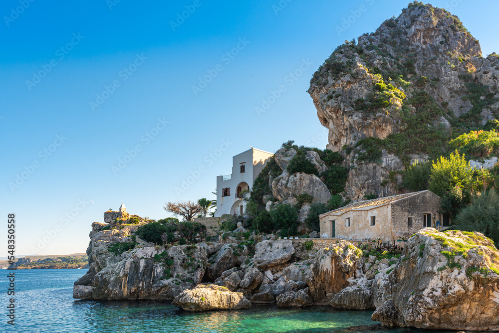 Fantastic geological landform of steep karst rocks in the cove of Scopello. The little bay housed the famous Tonnara of Scopello, a Tuna factory. The first buildings date back to the 13th century