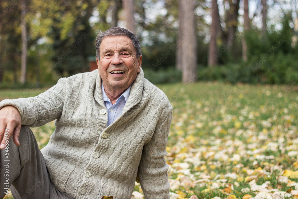 Portrait of a smiling senior man in an autumn park Portrait of a smiling senior man in an autumn park