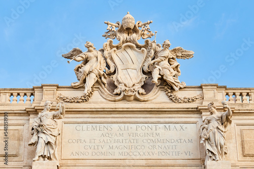 Trevi Fountain coat of arms with an inscription, Rome, Italy. Details of the papal coat of arms of Pope Clement XII on the top of Fontana di Trevi with crossed keys of Saint Peter.