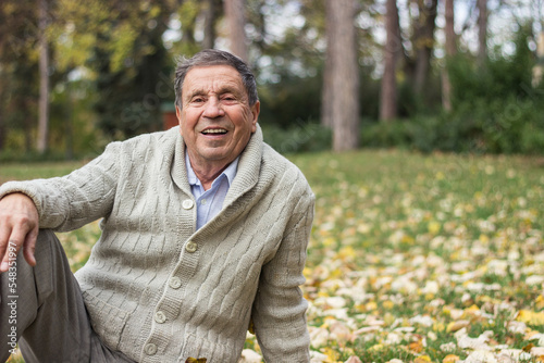 Portrait of a smiling senior man in an autumn park