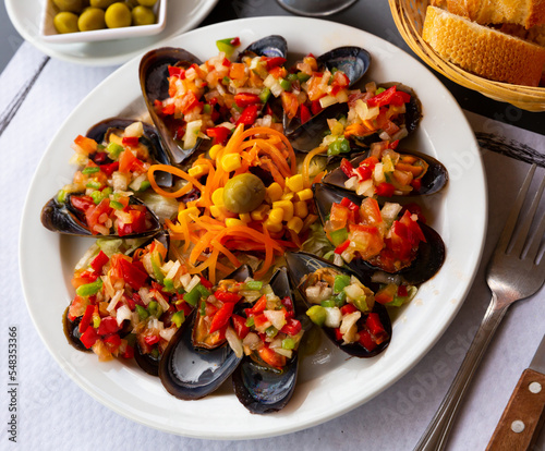 Tasty mussels with vinaigrette from fresh vegetables served at plate