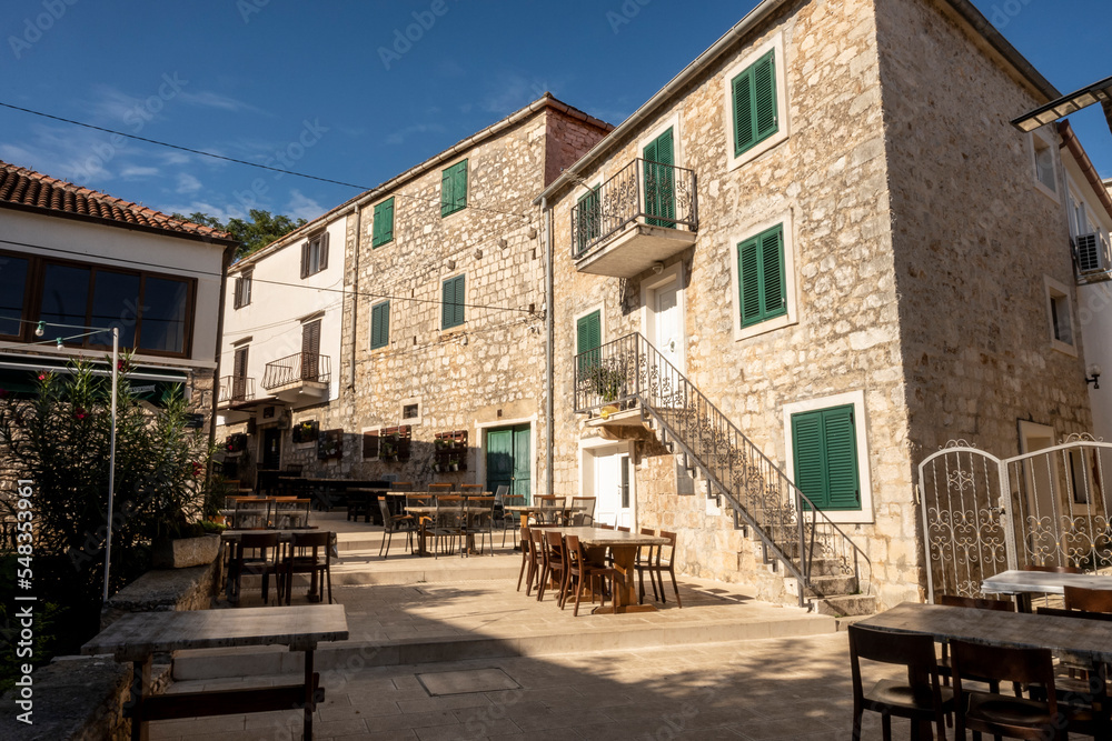 Lovely stone square and narrow, stone streets of Supetar, famous tourist destination on Brac island, Croatia