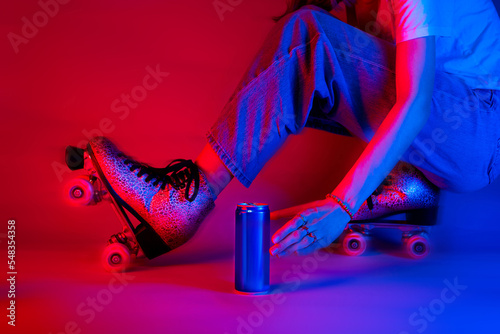 Roller skater reaching for a soda drink in a can while skating. Sports - red and blue pop art style poster.