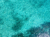 Beautiful turquoise shallows with sand bottom of Brac island beach, photographed with drone from above