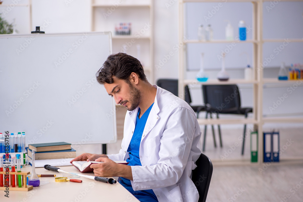Young male chemist working at the lab Young male chemist working at the lab