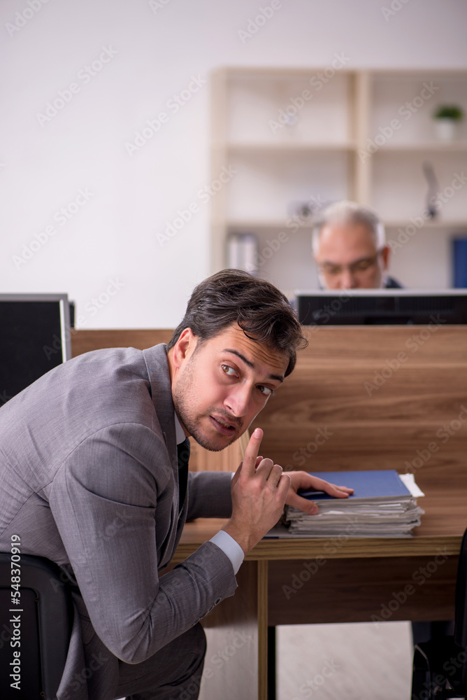 Two male colleagues working in the office Two male colleagues working in the office