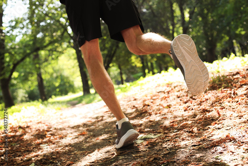 Man running in park, closeup. Morning exercise
