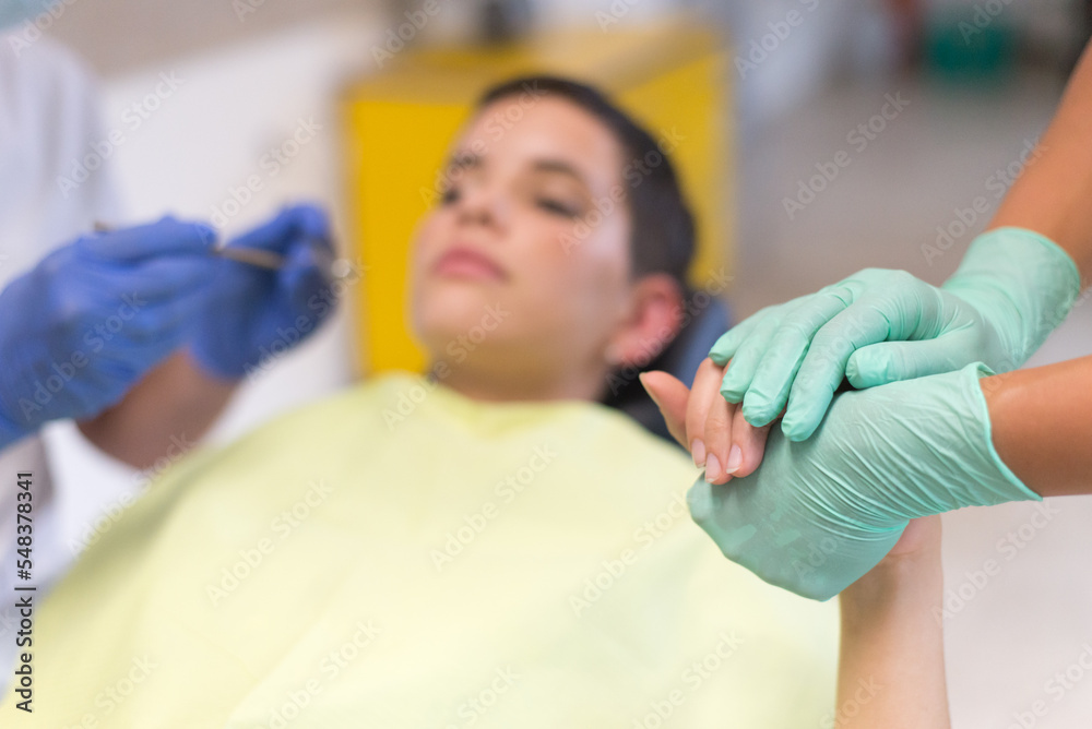 Obraz premium Young woman checking her teeth at the dentist clinic 