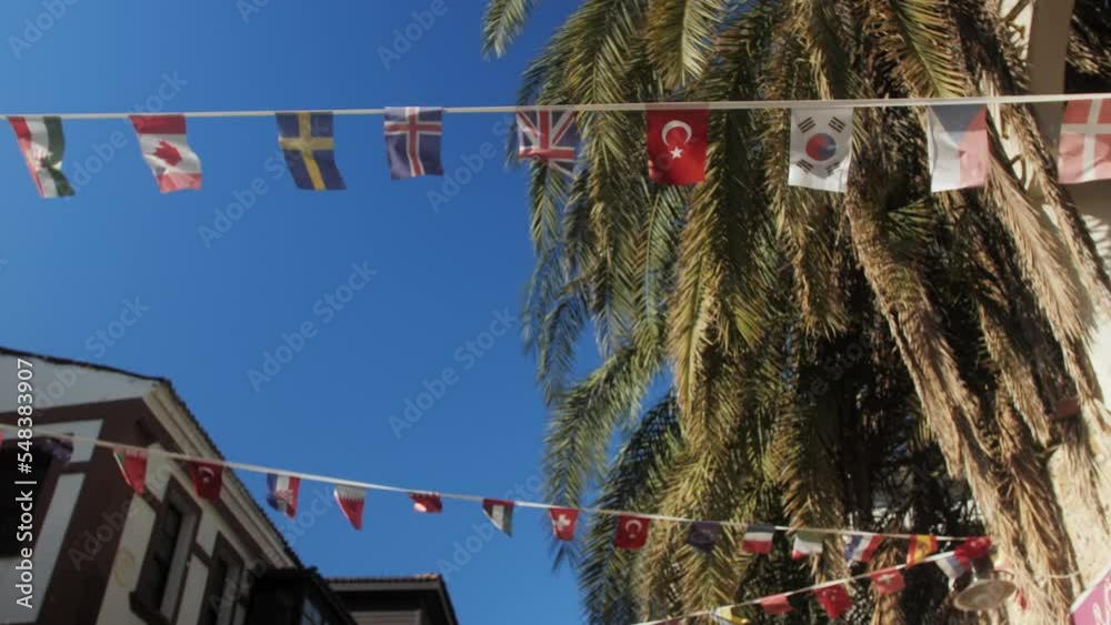 Different flags of all nations in the world in the street on hotel entrance.