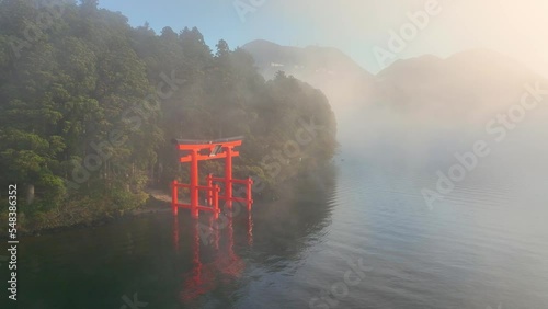Japanese culture, Hakone shrine with famous torii on the lake on magical foggy morning, tourism in Japan, aerial view of beautiful Japanese lake Ashino photo