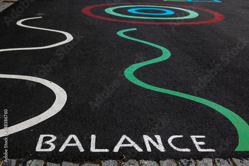 The inscription balance on the asphalt is a symbol of success and bank report.