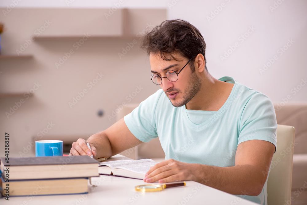 Young male student preparing for exams at home Young male student preparing for exams at home