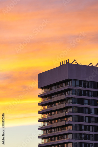 Photography Colorful sunset illuminating high level clouds over high rise apartment buildings