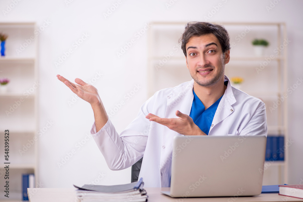 Young male doctor working in the clinic Young male doctor working in the clinic