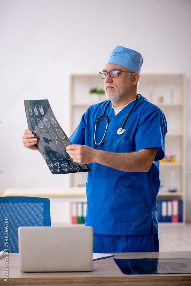 Old male doctor radiologist working in the clinic Old male doctor radiologist working in the clinic