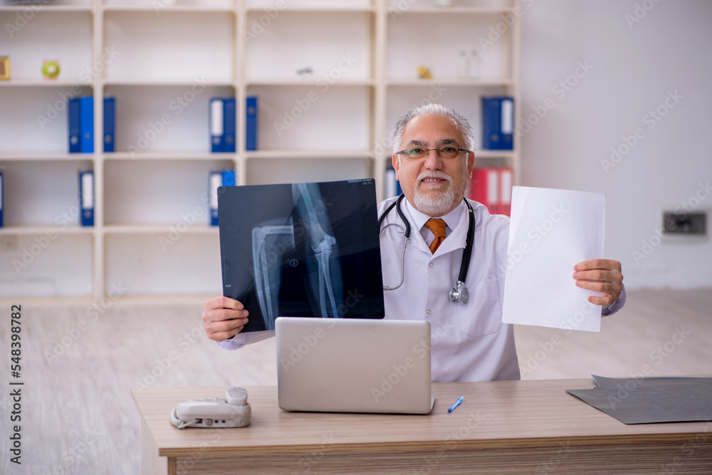 Old male doctor radiologist working in the clinic Old male doctor radiologist working in the clinic