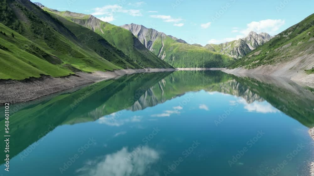 People Relax at Mountain Lake Lac de Grand Maison in French Alps - Aerial Dolly Forward