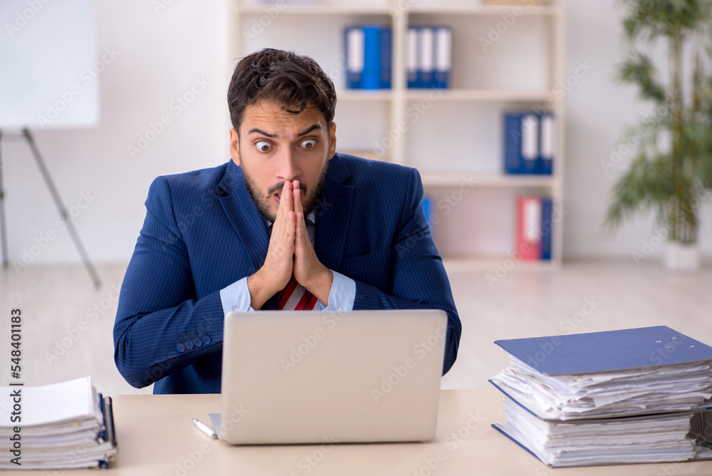 Young male employee working in the office