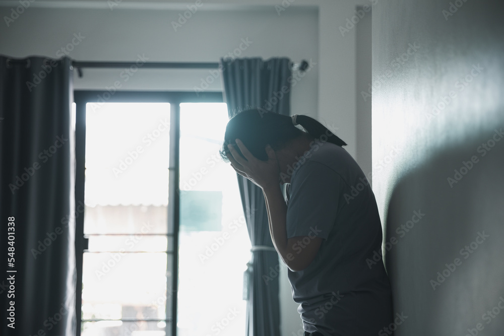 Schizophrenia with lonely and sad in mental health depression concept. Depressed woman standing against with dark room feeling miserable at home . Women are depressed, fearful and unhappy. Schizophrenia with lonely and sad in mental health depression concept. Depressed woman standing against with dark room feeling miserable at home . Women are depressed, fearful and unhappy.