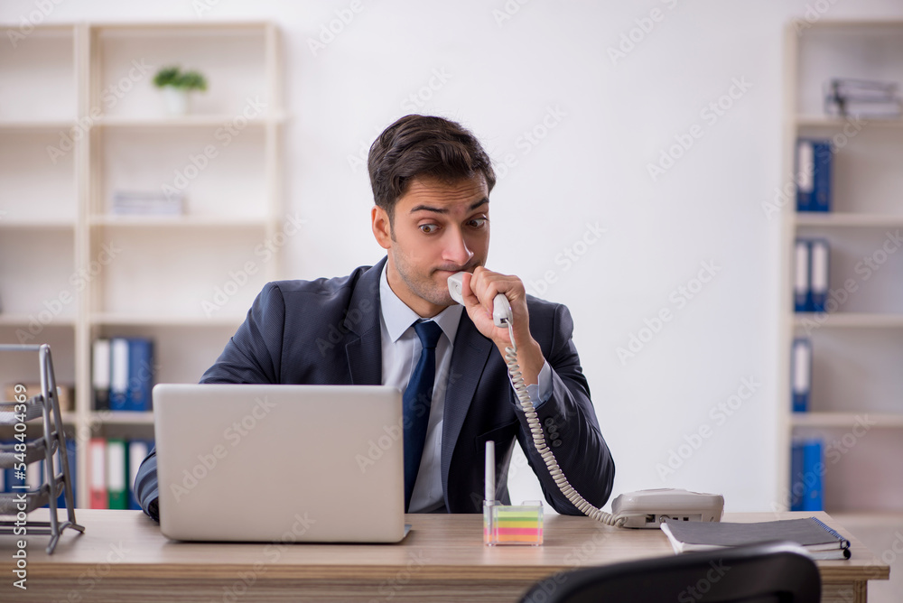 Young male employee working in the office