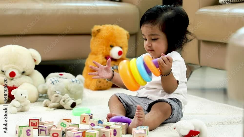 Stock video of a baby boy playing with his toys at home.